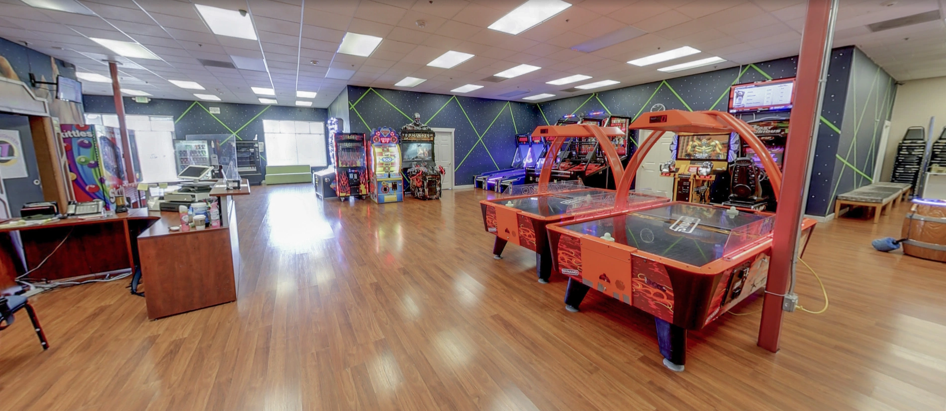 Indoor arcade game room with air hockey tables and video games