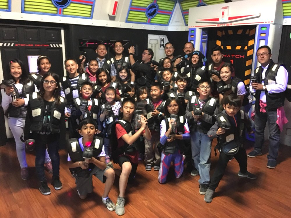 Family playing laser tag together at Laser Tagging Inc. in Newark, CA. Fun for kids, teens, and adults at the Bay Area's only two-story laser tag arena.