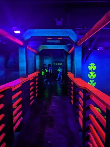 Futuristic neon-lit corridors wind through our two-story arena, creating tactical choke points and ambush zones at every turn. This is the architectural detail that separates our 7,000 sq. ft. vertical battlefield from every flat arena in the Bay Area.