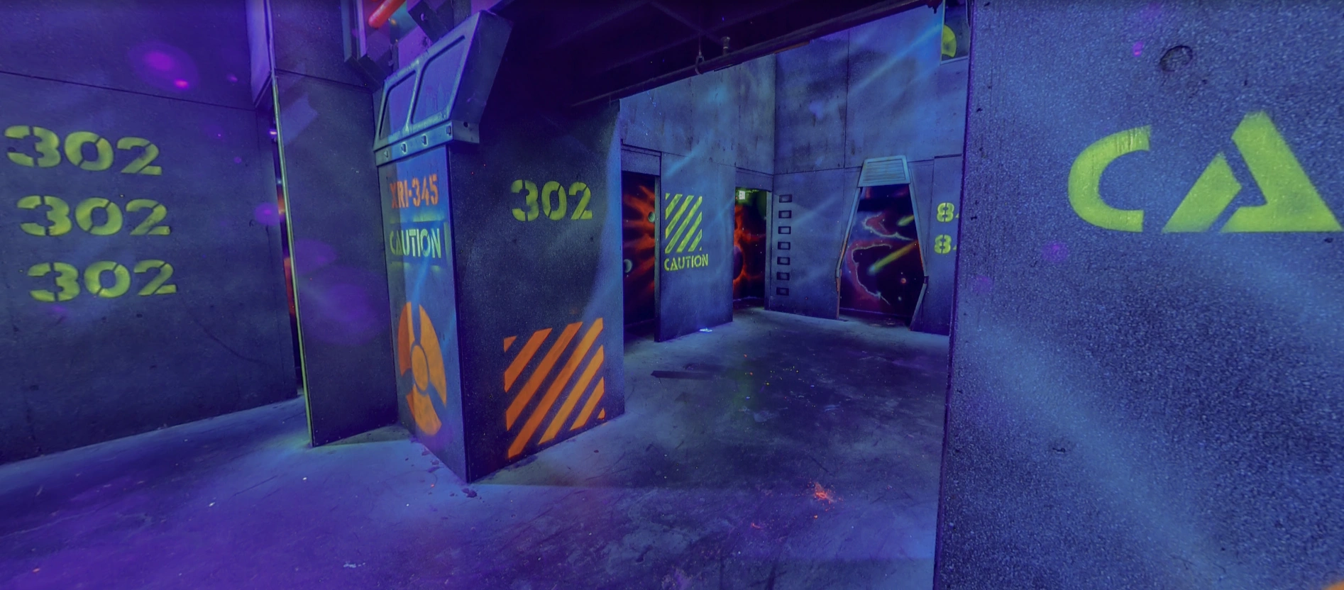 Neon-lit two-story laser tag arena with urban futuristic design