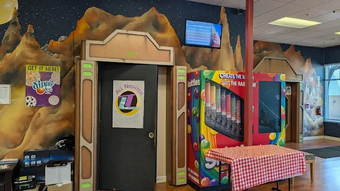 Space-themed arcade entrance with vending machines at the venue