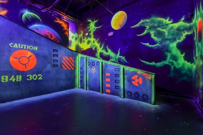 Neon glow-in-the-dark laser tag arena at Laser Tagging Inc. — the perfect setting for all-night laser tag events and lock-in parties in Newark, CA.