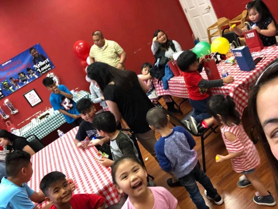 Children celebrating together at an indoor birthday party